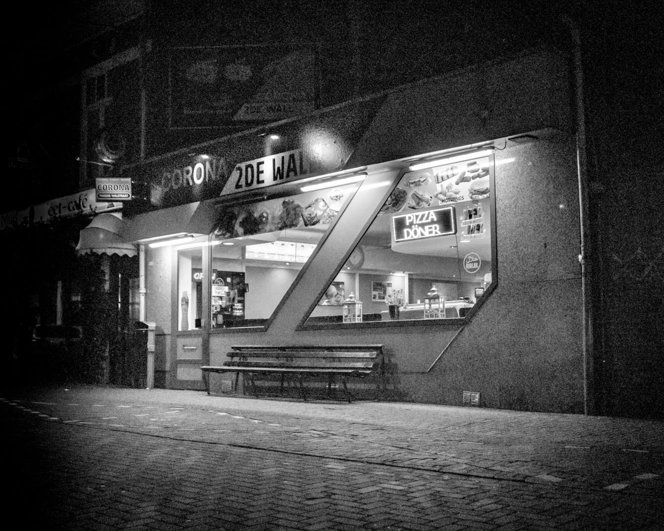 Lit shopfront at night on Tweede Walstraat, Nijmegen
